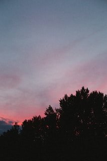 Evening sky painted with soft pinks and purples behind the silhouette of the hills.