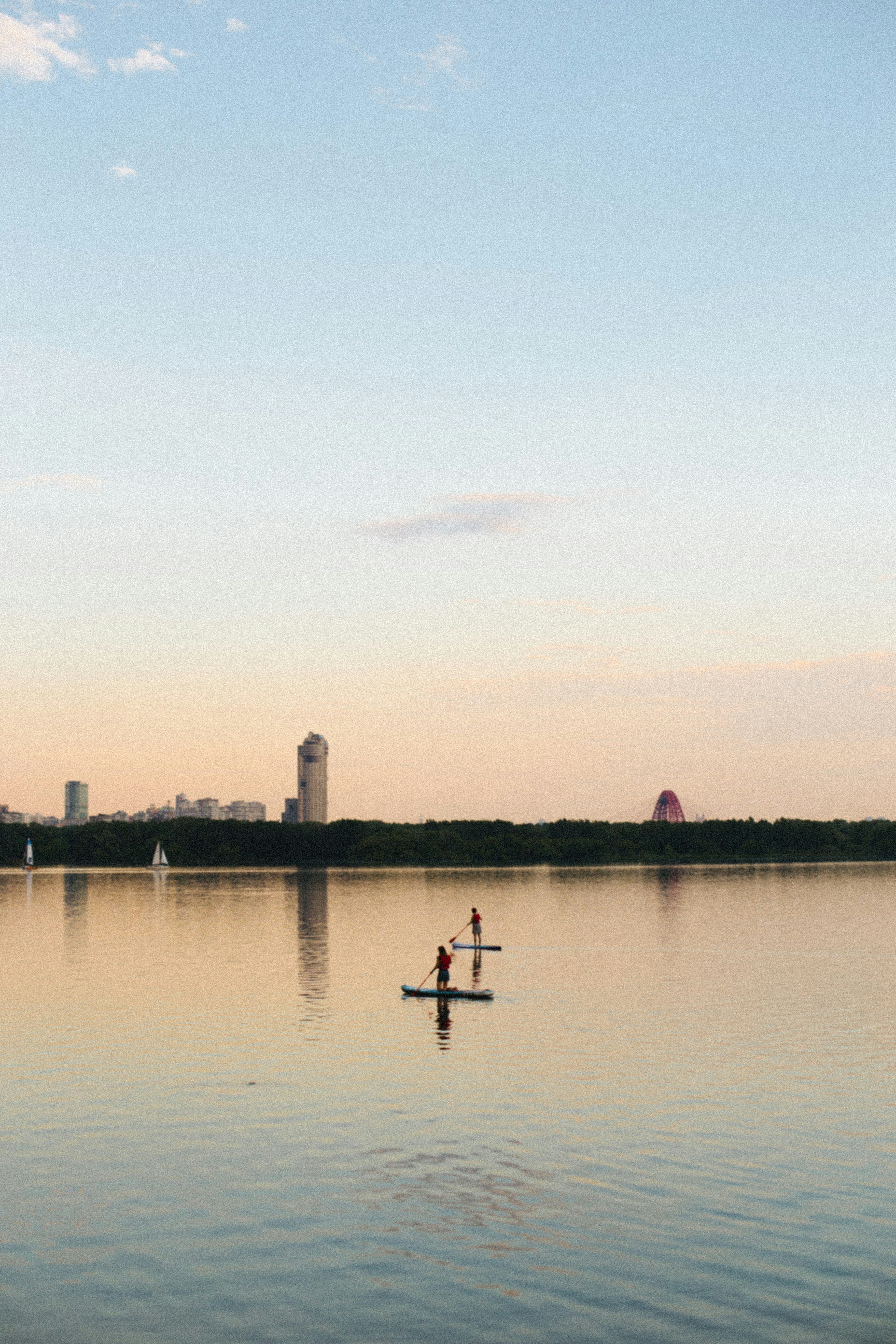 A couple of people on a boat in a body of water photo – Free Water ...