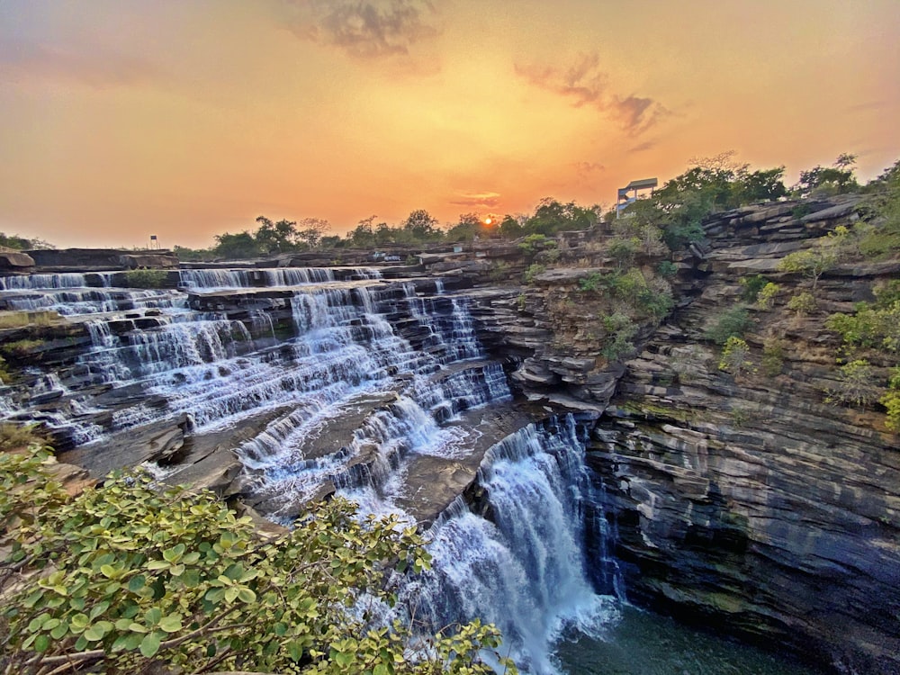 a waterfall with a building in the background