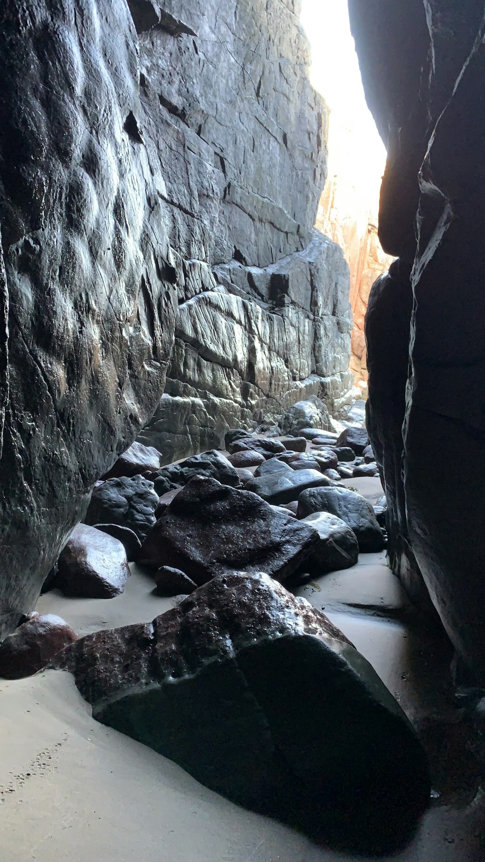 a rocky cave with a river