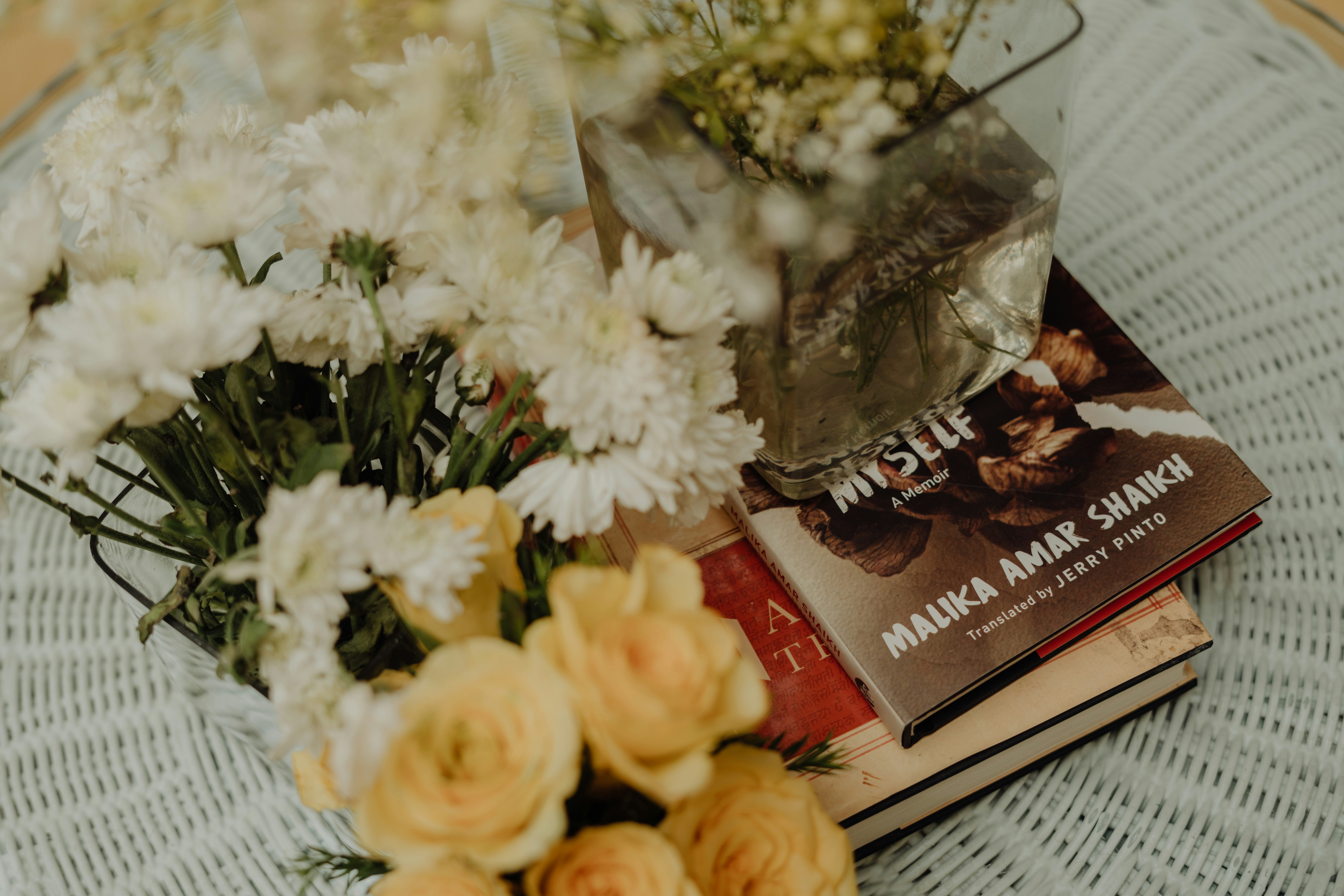a book and flowers on a table