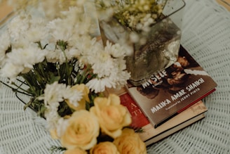 a book and flowers on a table
