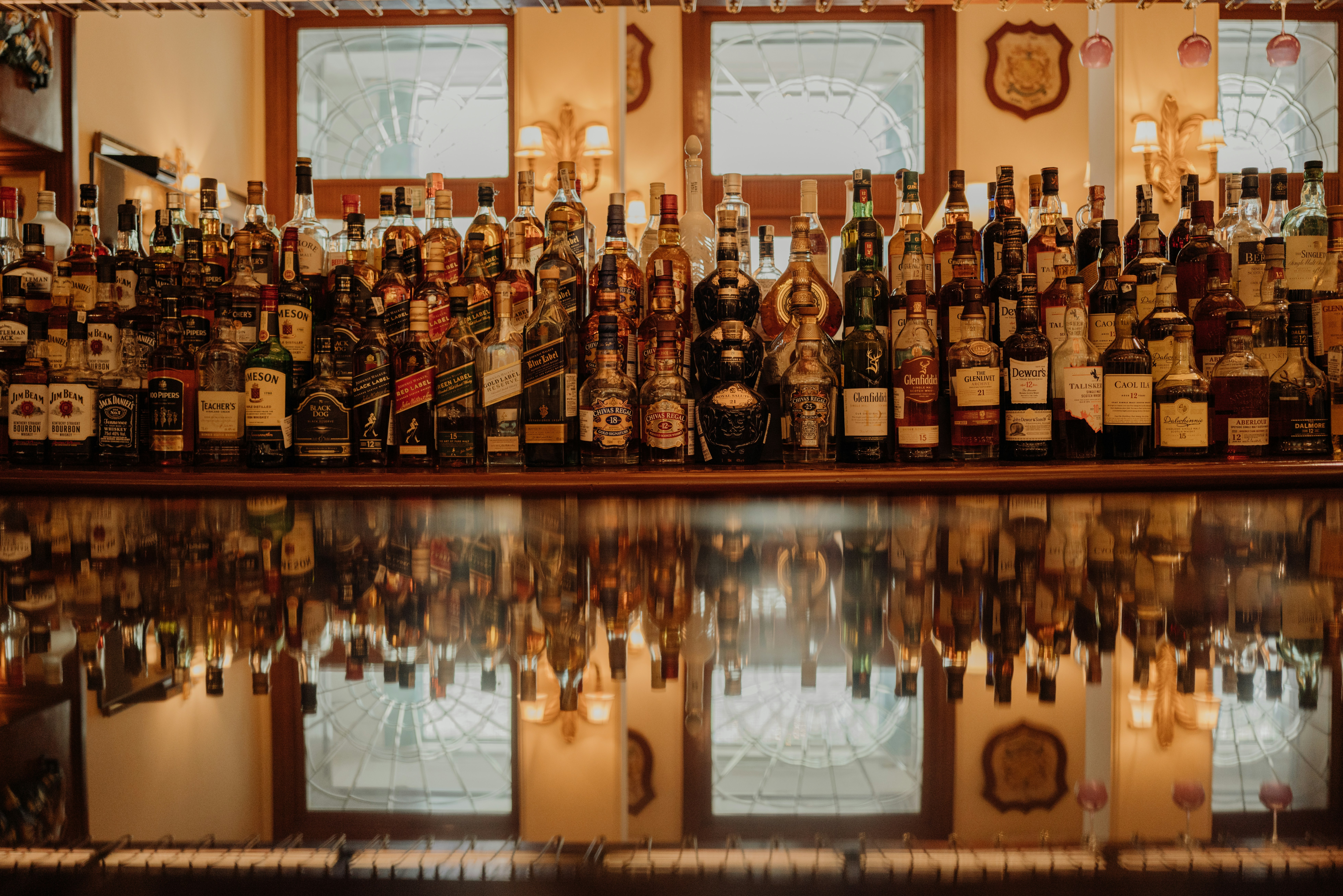 a shelf with bottles of alcohol on it