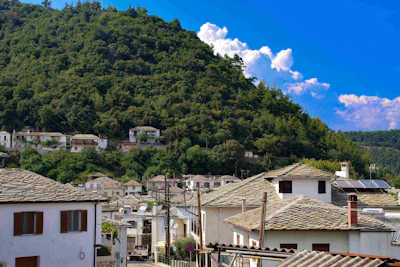 A quiet moment at a highland village with stone houses under a clear blue sky.