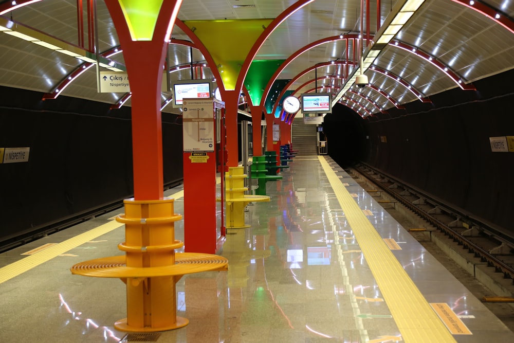 a train station with a yellow line