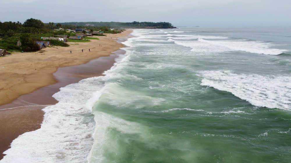 a beach with waves crashing on it