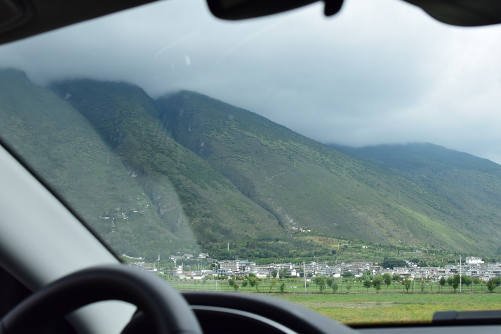 a view of a town and mountains from a car window