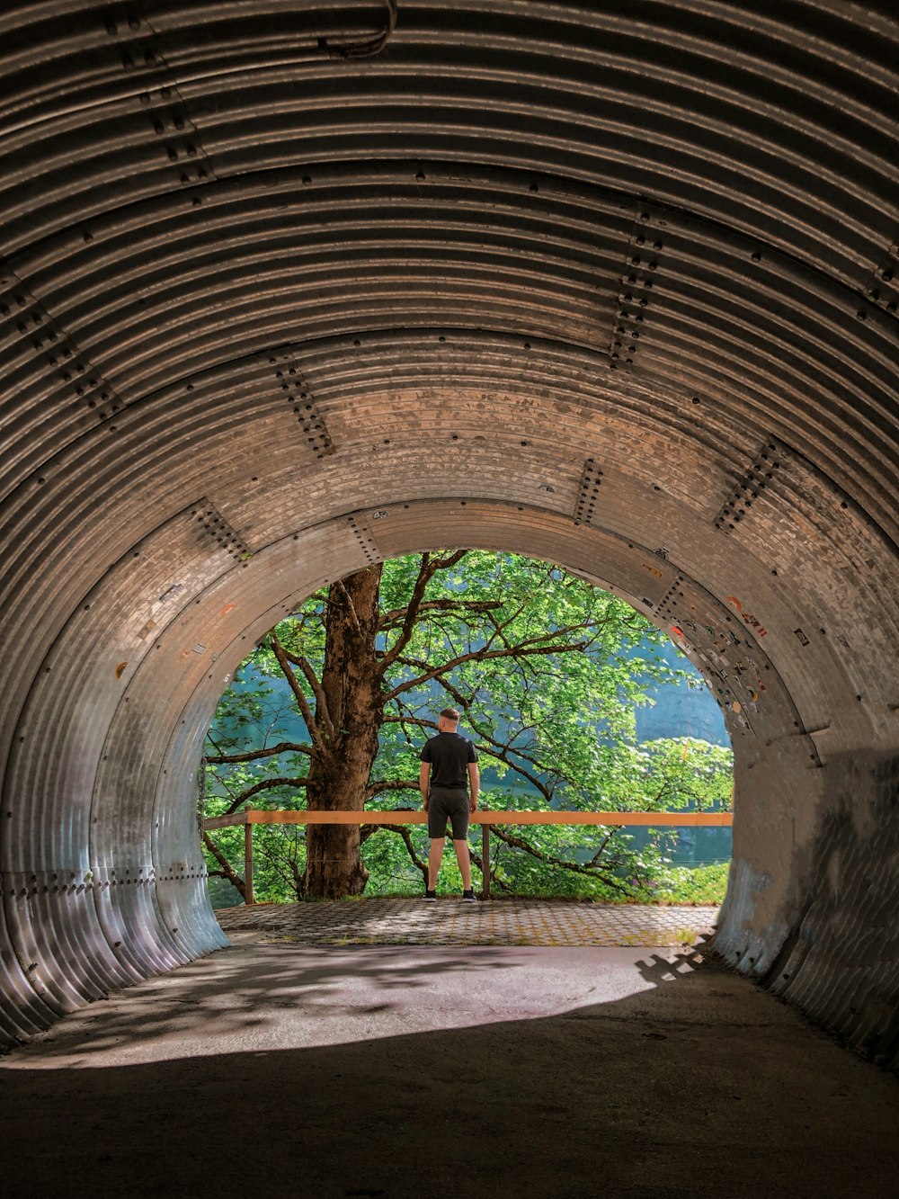a person standing in a tunnel