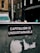 A sticker with white text on a black background reads 'Capitalism is Unsustainable.' It is placed on a weathered and possibly metallic surface with remnants of old stickers or paint. In the background, there is an urban street scene with blurred buildings and a van, suggesting a city setting.