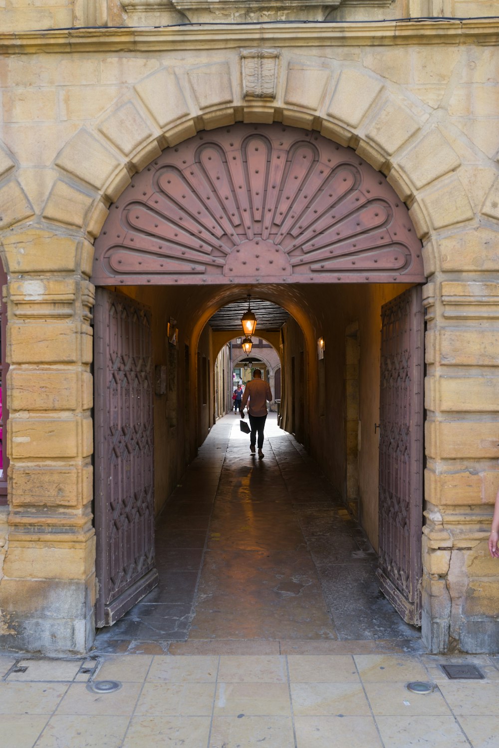 a person walking through an archway
