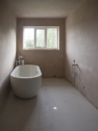 Sleek modern bathroom with a freestanding tub and minimalist fixtures.