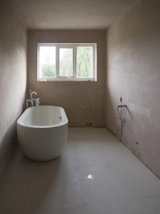 Sleek modern bathroom with a freestanding tub and minimalist fixtures.