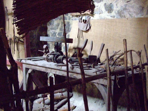 A rustic wooden desk with tools and wood samples representing a woodworking business.