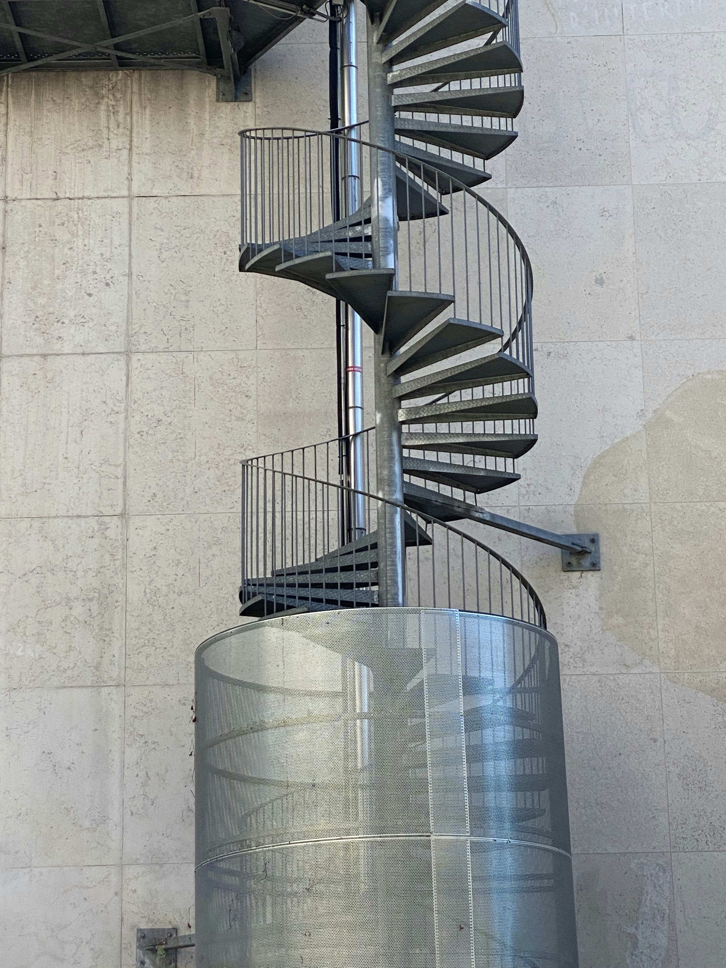 a large metal cylinder with a metal railing
