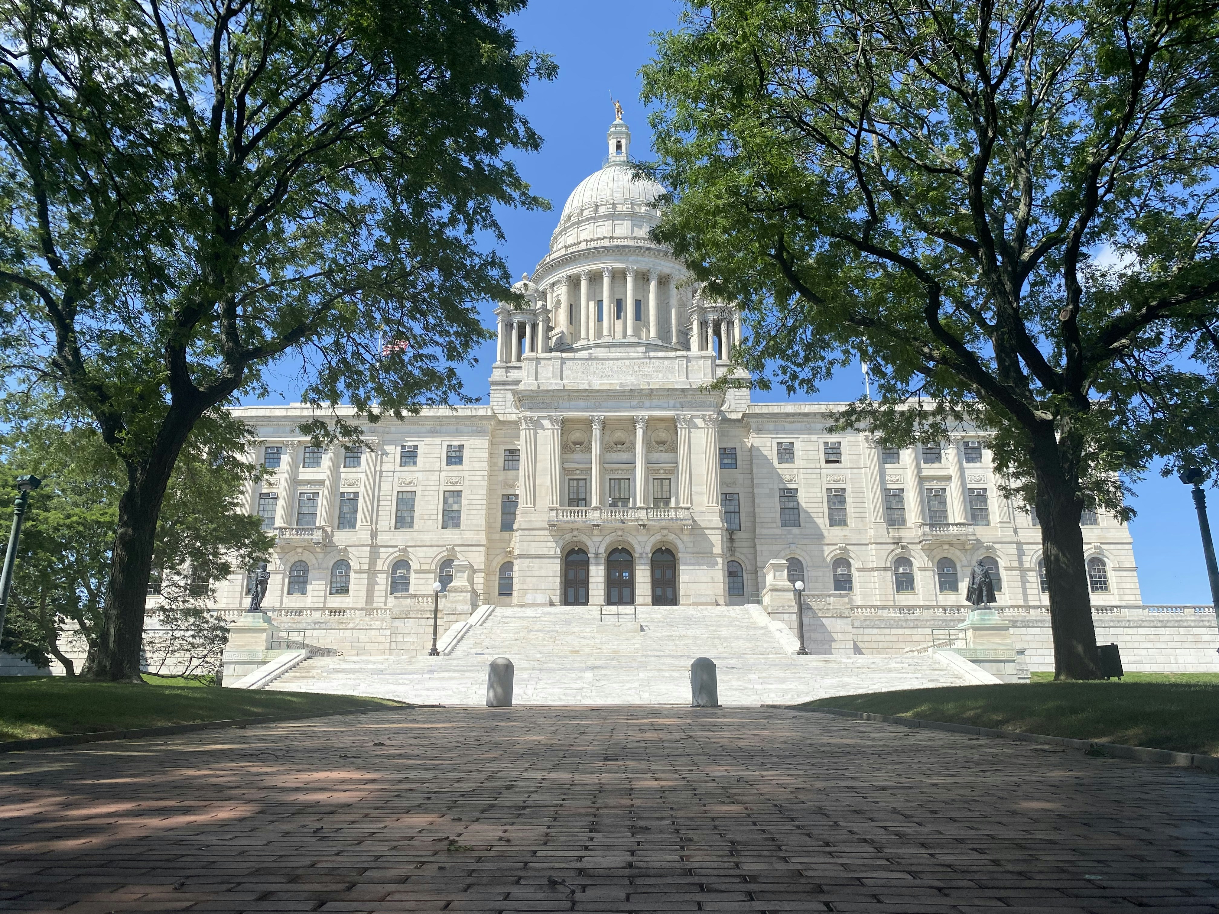 a large white building with trees in front of it