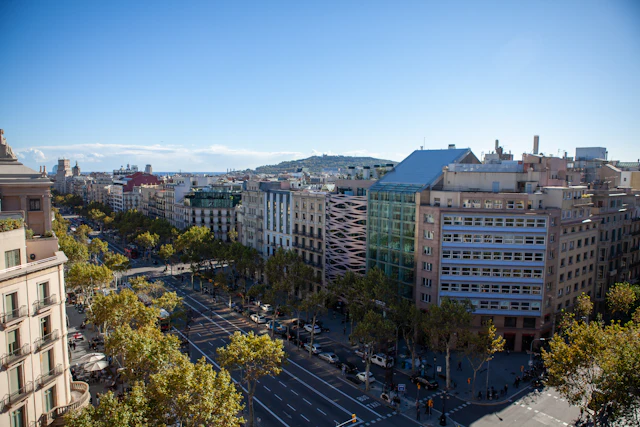 An elevated view down Passeig de Gracia's tree-lined boulevard with its grand Eixample buildings