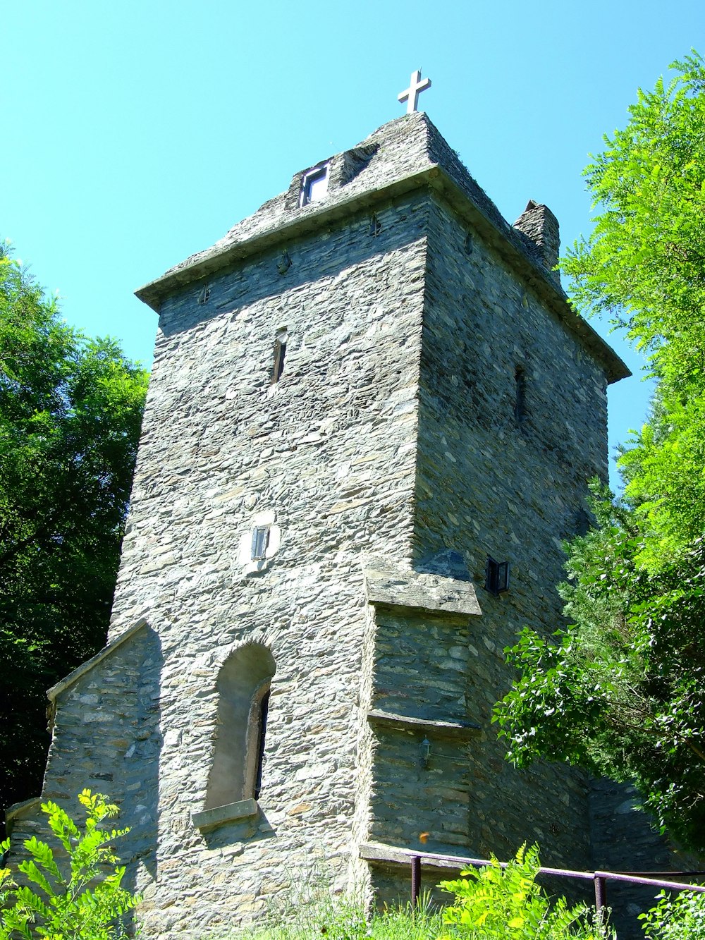 a stone building with a cross on top