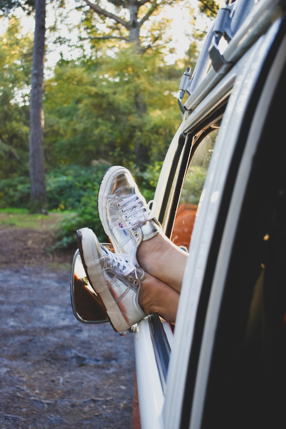 a person's foot on a car window