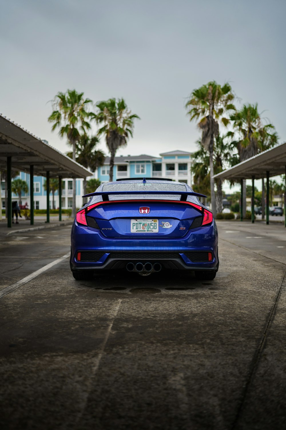 a blue car parked on a street