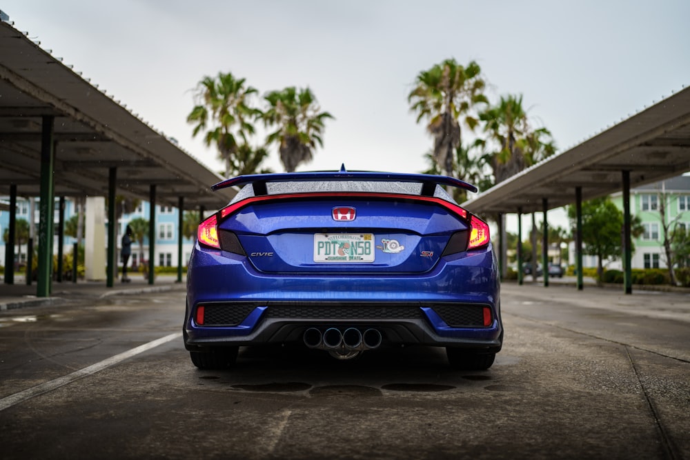 a blue car parked in a parking lot