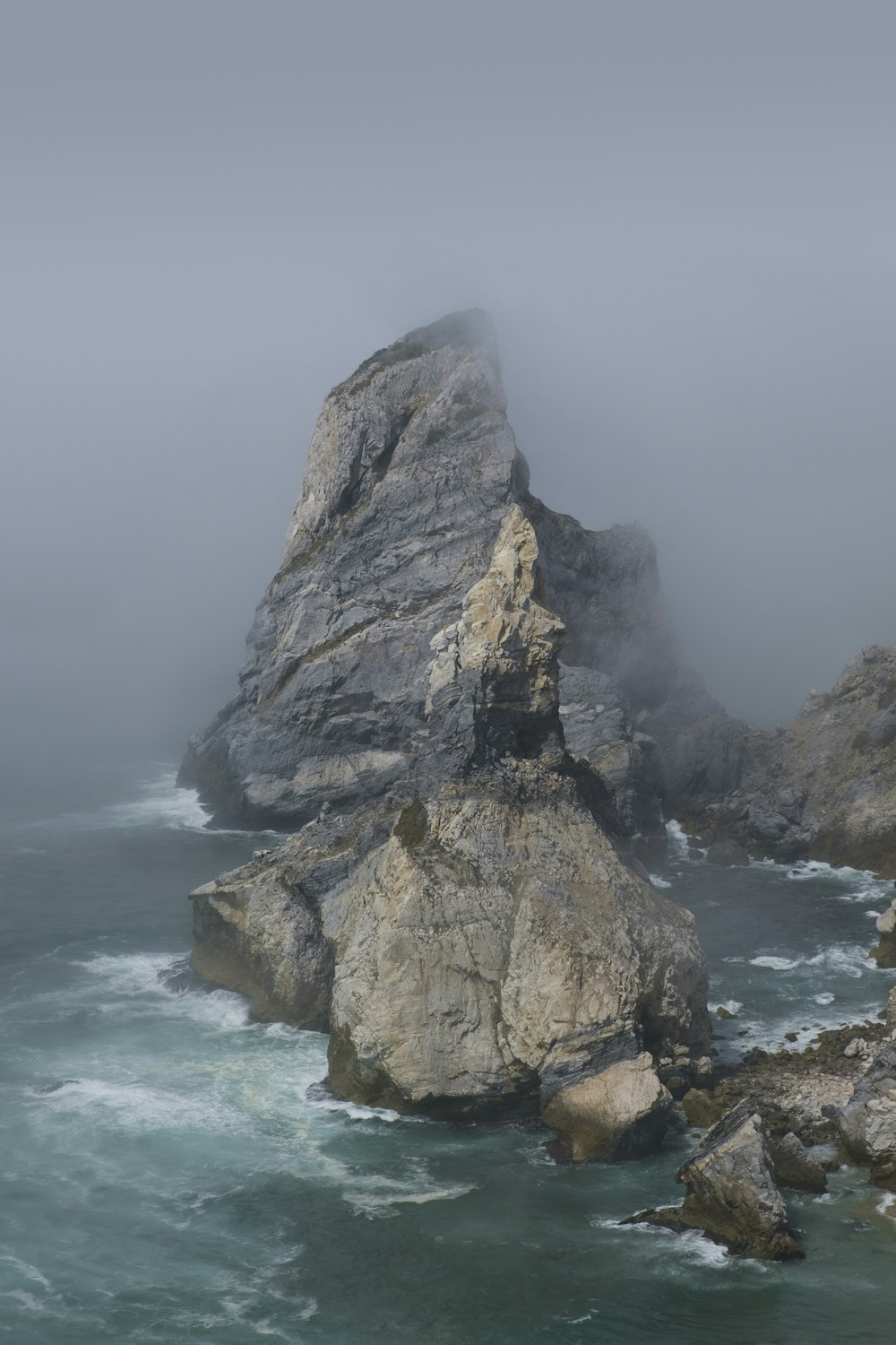 a large rock formation in the ocean