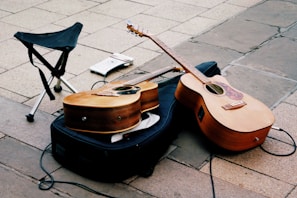 a guitar and a chair on a sidewalk