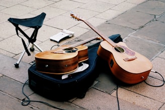 a guitar and a chair on a sidewalk