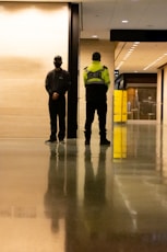 a couple of police officers standing in a hallway