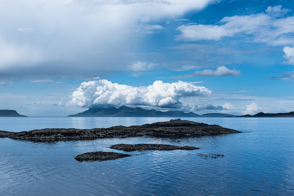 a group of small islands in the water with a large cloud of smoke