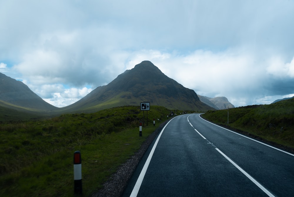 a road with a mountain in the background