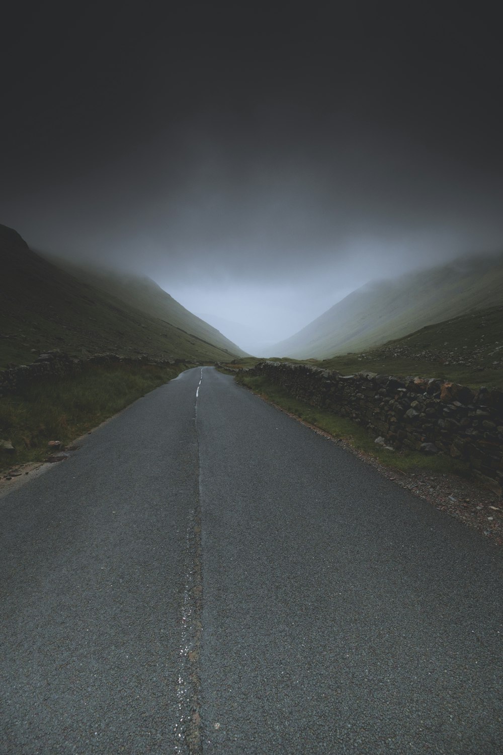a road with a foggy sky