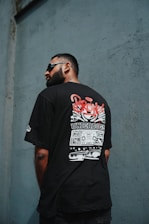 a man wearing a black boxy t-shirt