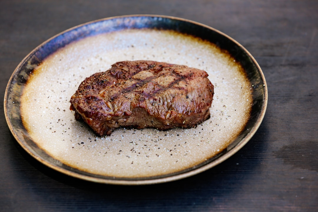 a piece of meat on a plate, Rib-eye Steak