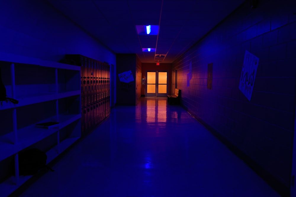 a dark hallway with a light on