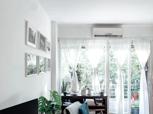 a room with a table and a window with curtains
