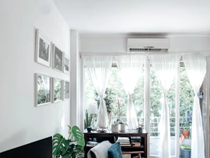 a room with a table and a window with curtains