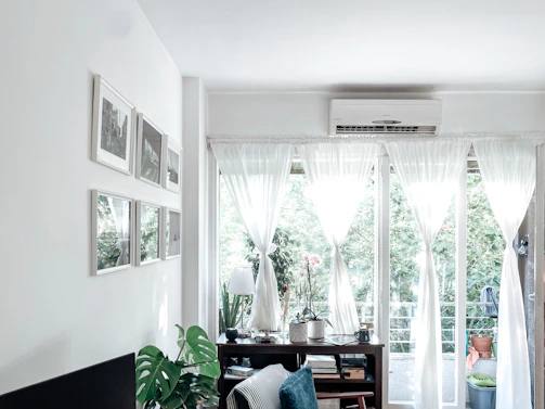a room with a table and a window with curtains