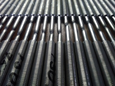 Close-up of shiny brazing alloy rods arranged neatly on a metal surface.