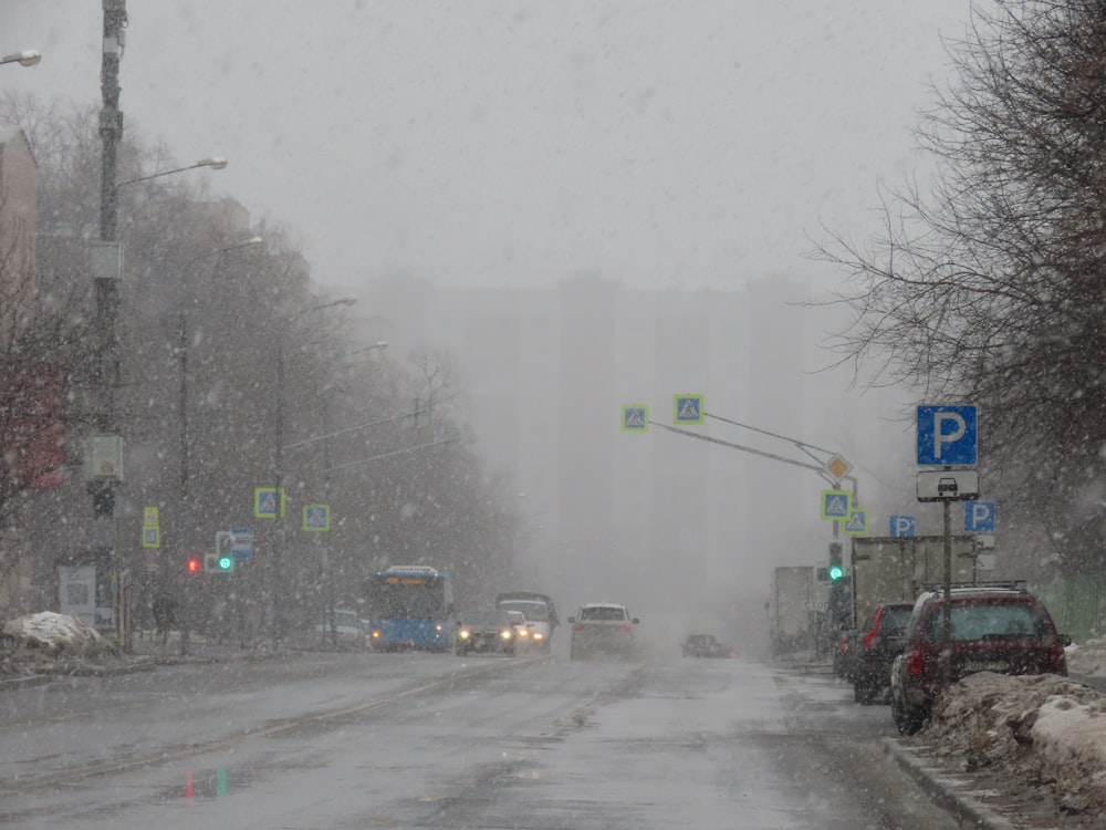 a snowy street with cars and trucks