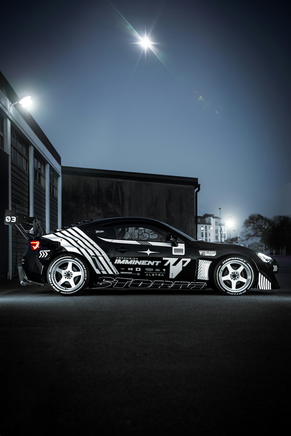 a black sports car parked on a street at night