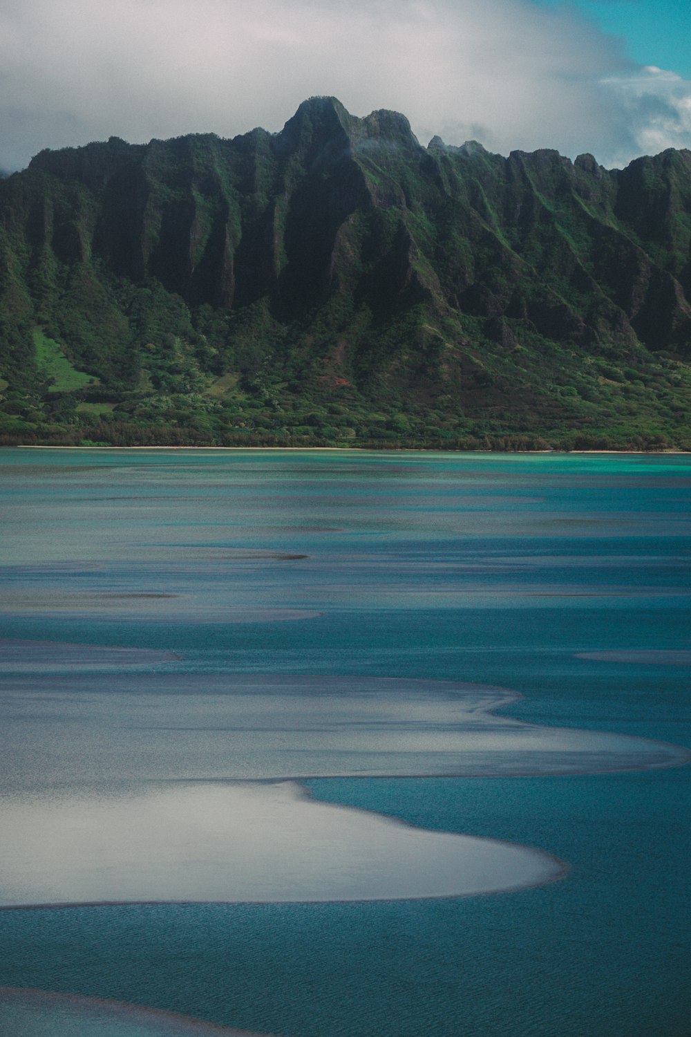 a body of water with a mountain in the background