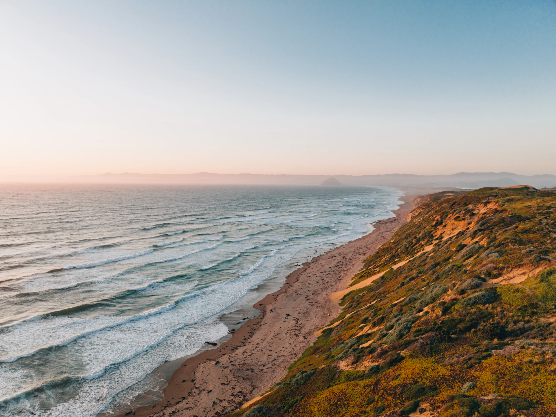 woman wearing yellow long-sleeved dress under white clouds and blue sky during daytime