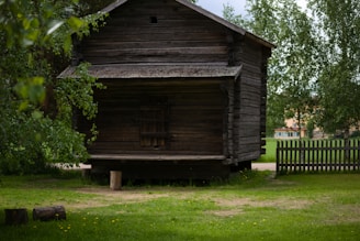 a wooden building with a fence around it