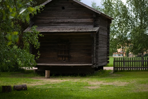 a wooden building with a fence around it