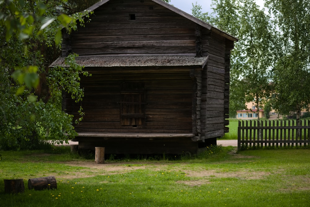 a wooden building with a fence around it