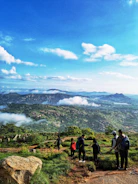 Group of friends hiking in the Swiss Alps with panoramic mountain views.