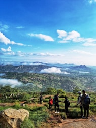A group of travelers enjoying a scenic mountain hike with panoramic views.