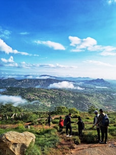 A group of travelers enjoying a scenic mountain hike with panoramic views.