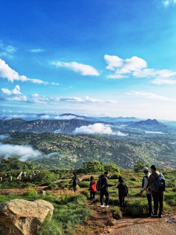 A family enjoying a scenic hike on a sunny day with panoramic views.