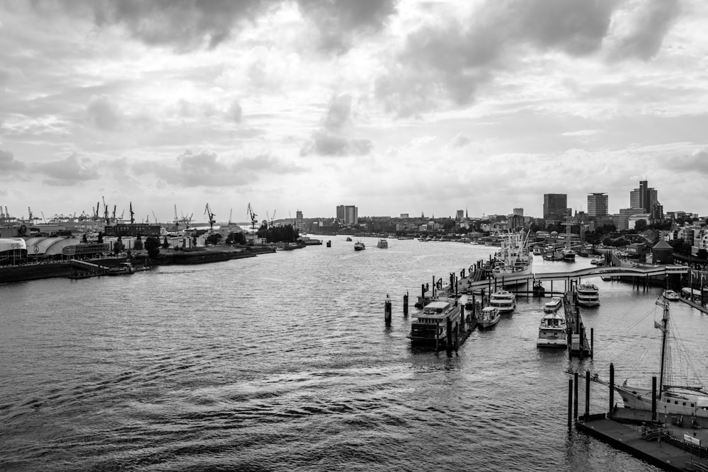 a body of water with boats in it and a city in the background